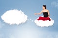 Young girl sitting on cloud and thinking of abstract speech bubble with copy space Royalty Free Stock Photo