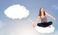 Young girl sitting on cloud and thinking of abstract speech bubble with copy space Royalty Free Stock Photo