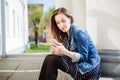 Young girl sitting on the college campus yard Royalty Free Stock Photo