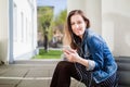 Young girl sitting on the college campus yard listening to music Royalty Free Stock Photo