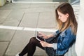 Young girl sitting on the college campus yard studying Royalty Free Stock Photo