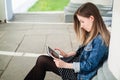 Young girl sitting on the college campus yard studying Royalty Free Stock Photo