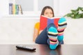 Young girl sitting on couch and reading. Royalty Free Stock Photo