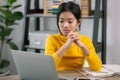 A young girl is sitting at a desk with a laptop open in front of her Royalty Free Stock Photo