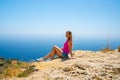 Young girl sitting on the edge of the cliff Royalty Free Stock Photo