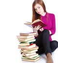 Young girl is sitting on a floor and reading book Royalty Free Stock Photo