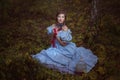 Young girl sitting on the grass.