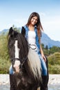 Young girl sitting on horse while crossing river Royalty Free Stock Photo