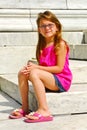 Young Girl Sitting on Marble Steps Royalty Free Stock Photo