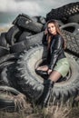 Girl sitting in the tyres