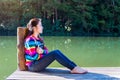 Young girl sitting on a pier. Royalty Free Stock Photo