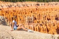 Young girl sitting by the scenic view of stunning red sandstone hoodoos Royalty Free Stock Photo