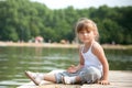 Young girl sitting sitting in a pier