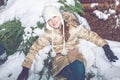 Young girl sitting on snow in evening winter forest Royalty Free Stock Photo