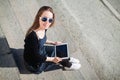 Young girl sitting on the steps of a college campus yard Royalty Free Stock Photo