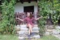 Young girl sitting on the steps of an old rural house.