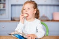 Young Girl Sitting At Table Eating Potato Chips Royalty Free Stock Photo