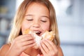 Young Girl Sitting At Table Eating Sugary Donut Royalty Free Stock Photo