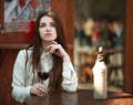 Young girl sitting at table in summer cafe with glass of wine Royalty Free Stock Photo