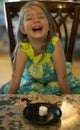 Young girl sitting at a table waiting patiently for a marshmallow