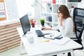 Young girl sitting at the table and working with a computer, documents and calculator Royalty Free Stock Photo