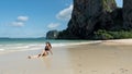 Young girl sitting in water at beach on tropical island Royalty Free Stock Photo