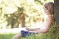 Young Girl Sketching In Countryside Leaning Against Tree Royalty Free Stock Photo