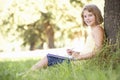 Young Girl Sketching In Countryside Leaning Against Tree Royalty Free Stock Photo