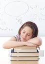 Young girl sleeping on books at school Royalty Free Stock Photo