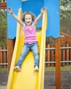 Young girl on slide in playground