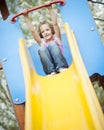 Young girl on slide in playground