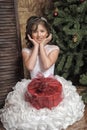 Young Girl In A Smart White Dress With A Gift In Christmas