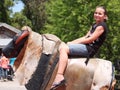 Young Girl Riding Mechanical Bull Royalty Free Stock Photo