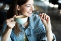 Young girl smiling and drinking delicious coffee