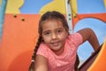 Young Girl Smiling, Looking out from Play Equipment