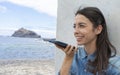 Young girl smiling and speaking consulting and giving instruction with voice recognition. Woman with audio recording in smart