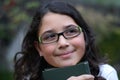 Young girl smiling wearing green glasses