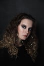 Young girl with smoky eye makeup and fancy ring earrings, selective focus, grainy