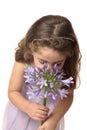 Young girl sniffing flower