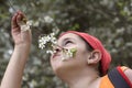 Young girl sniffing flower