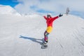 Young girl snowboarder in motion on snowboard in mountains Royalty Free Stock Photo