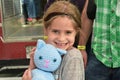 Young Girl Snuggles Crochet Cat from Nashville Cat Rescue at Oktoberfest Event