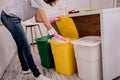 Young girl sorting garbage at the kitchen. Concept of recycling. Zero waste