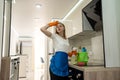 a young girl in special gloves with a rag cleaned the kitchen and was very tired Royalty Free Stock Photo