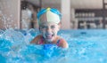 Young Girl Splashing Swimming Pool