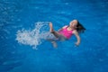 Young Girl Splasing in Pool