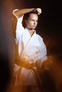 Young girl in a sports kimono in the image of judo. Royalty Free Stock Photo