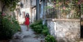 Young girl standing in alley in Greek village