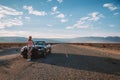 Young girl standing by the black Ford Mustang GT