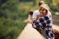 Young girl is standing on a  bridge and enjoys the view Royalty Free Stock Photo